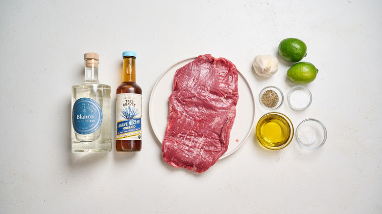Margarita-inspired marinated flank steak ingredients on a table