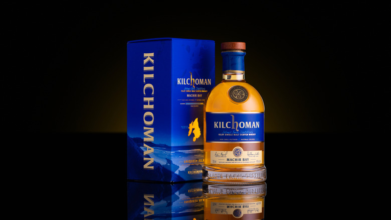 Stylized shot of Kilchoman Machir Bay and its packaging on a dark background