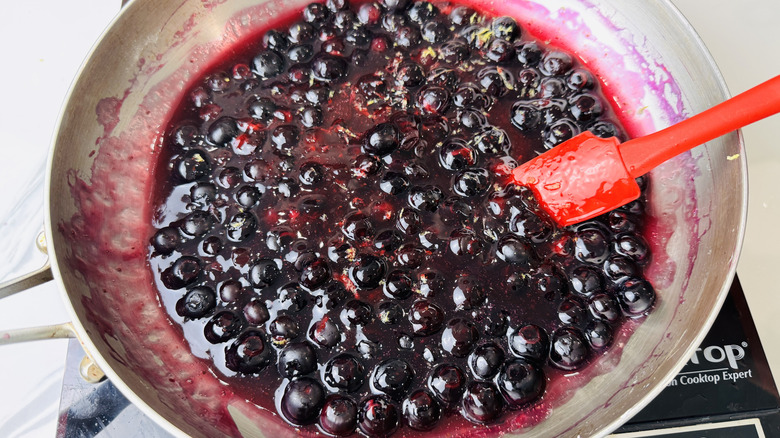 Blueberry topping with lemon zest in saucepan