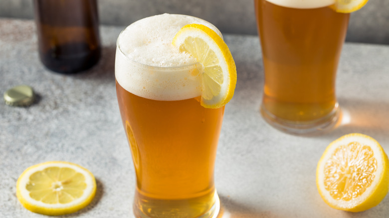 Glasses of beer with lemon slices