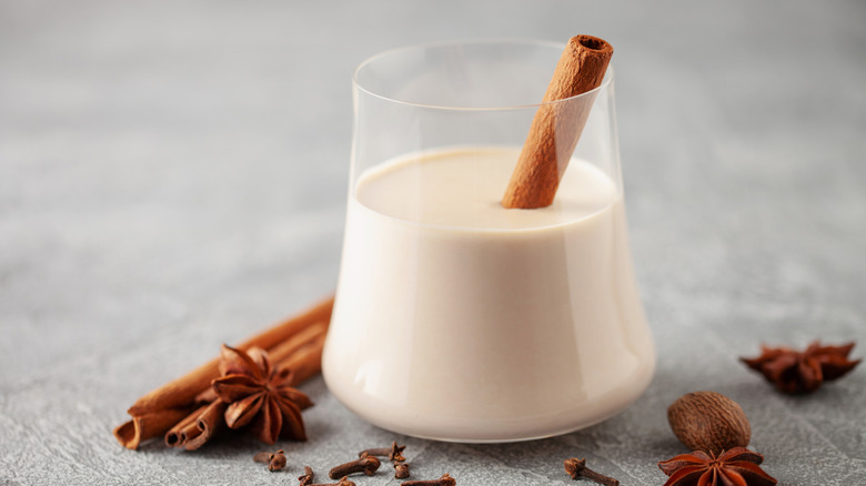 Glass of coquito with cinnamon stick