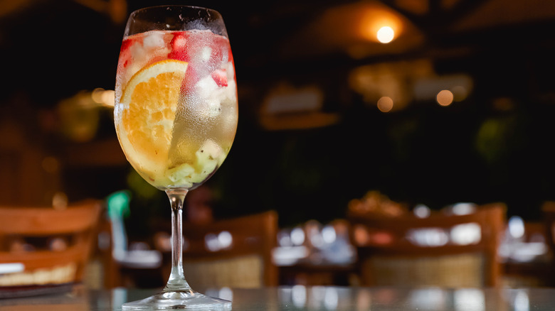 Clericó served in a wine glass with chopped fruit.