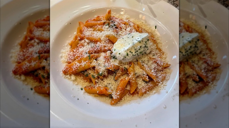 Mirrored image of four cheese pasta on white plate