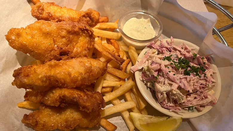 Battered pieces with fries and slaw, close up