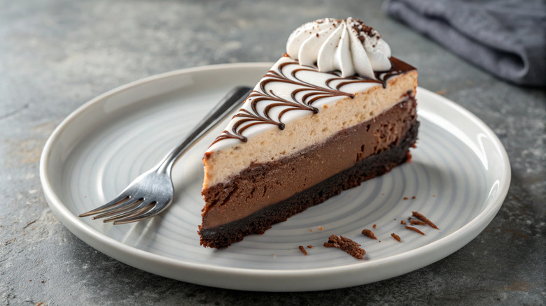 A slice of cheesecake from The Cheesecake Factory on grey table