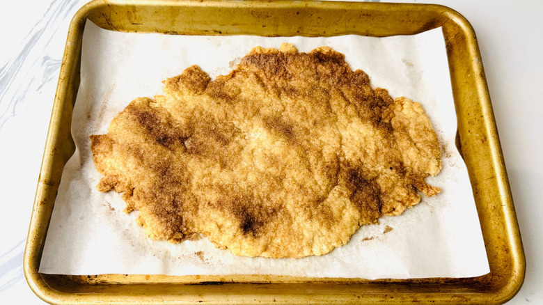 Baked cinnamon sugar pie crust on baking sheet