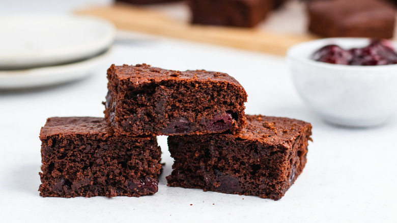 Stack of three squares of chocolate cherry cake