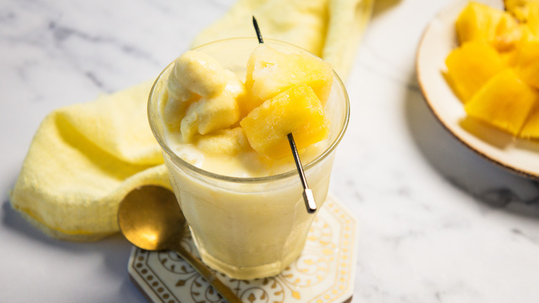 A glass of Dole Whip float with a spoon.