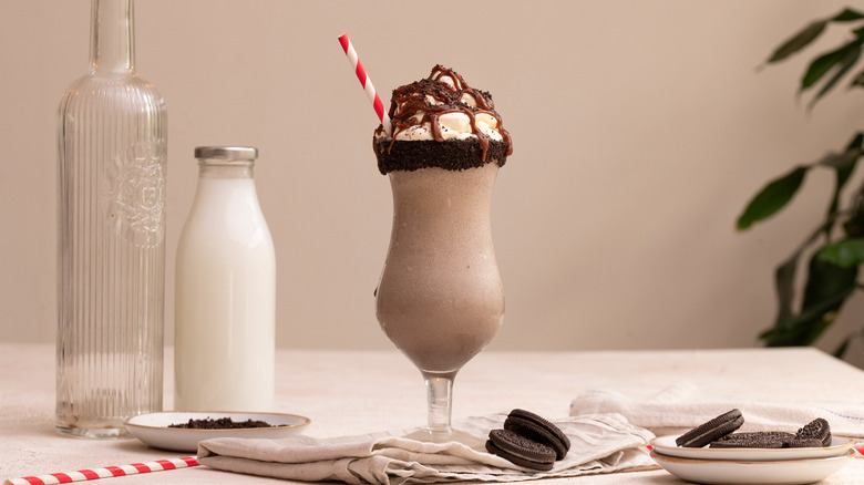 Cookies and cream milkshake with straw and chocolate drizzle