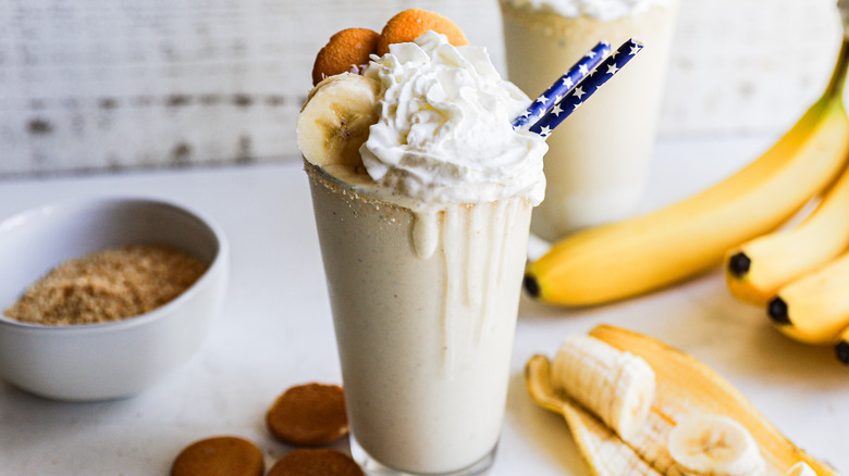 Banana pudding milkshake with whipped cream and vanilla wafer garnish