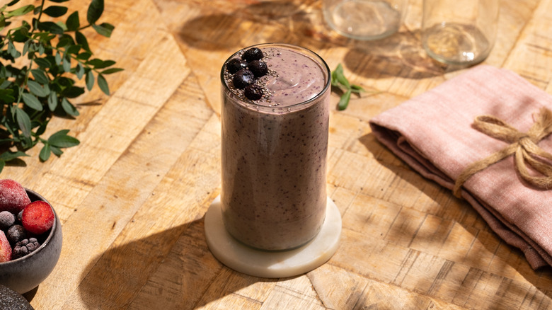 Berry smoothie in glass garnished with blueberries