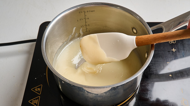 stirring frosting ingredients with a spatula