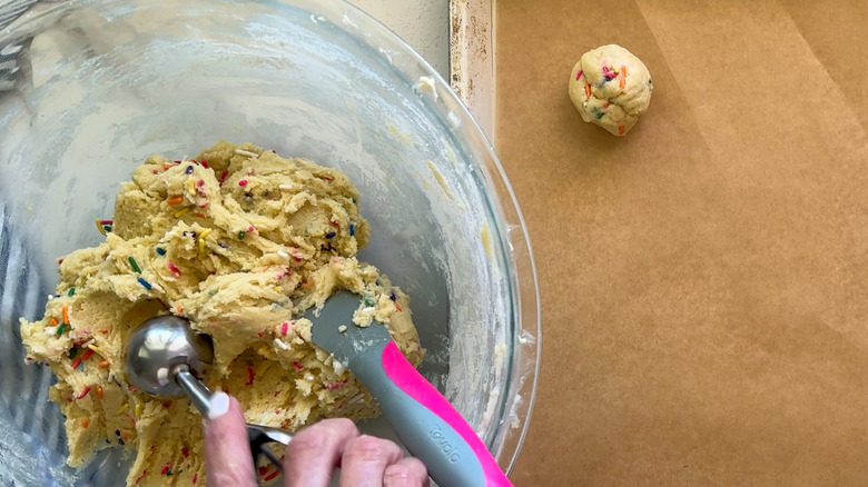 hand scooping out dough