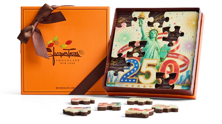 Jacques Torres Lady Liberty puzzle chocolate with pieces taken out on white background