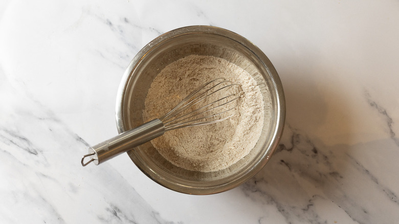 Whisking dry ingredients in bowl.