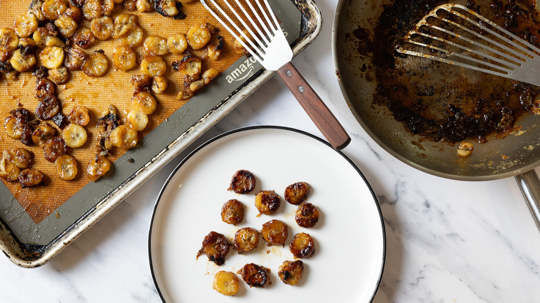Flambeed bananas on plate, on baking sheet, and besides pan with bourbon drippings.