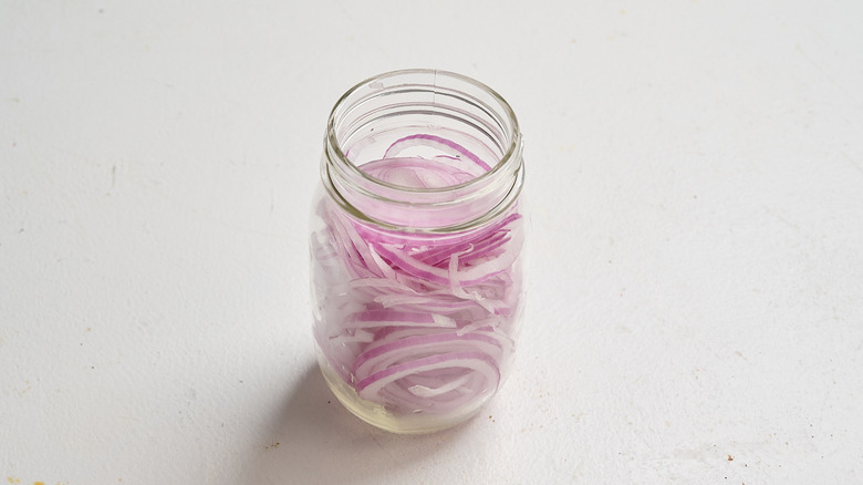 sliced onions in a jar