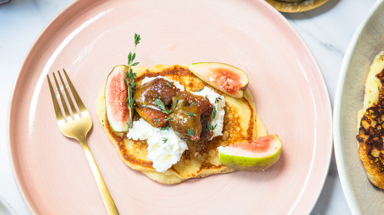 One goat cheese pancake on a plate.