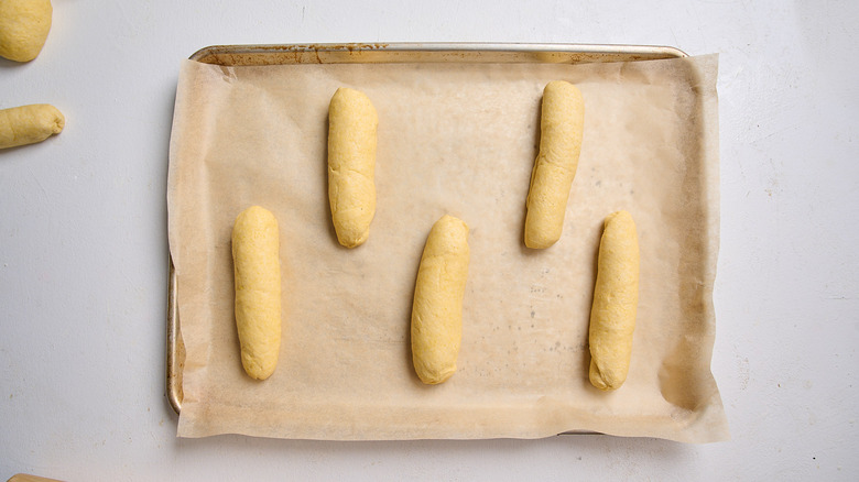 dough logs arranged on a baking sheet
