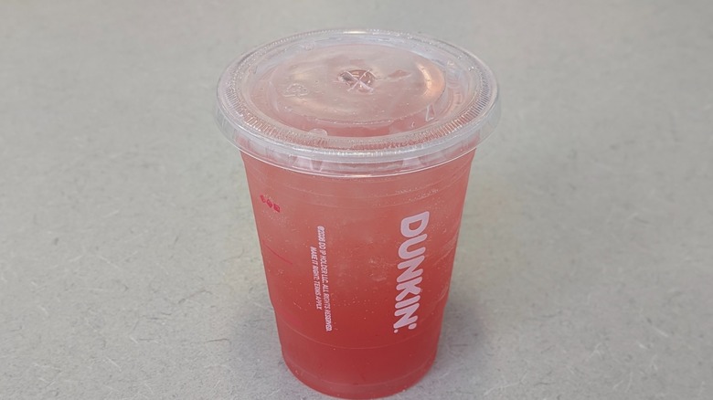 A Watermelon Lime Dunkin' Zero on a grey table