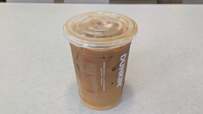 A Peanut Butter Shakin' Espresso from Dunkin' on a grey table