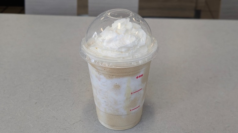 A Fluffernutter Coffee Chiller from Dunkin' on a grey table