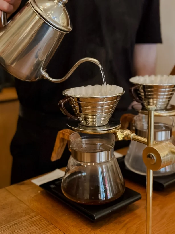 A barista making pour over coffee