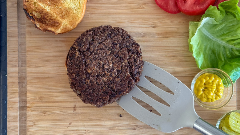 spatula placing burger on bun