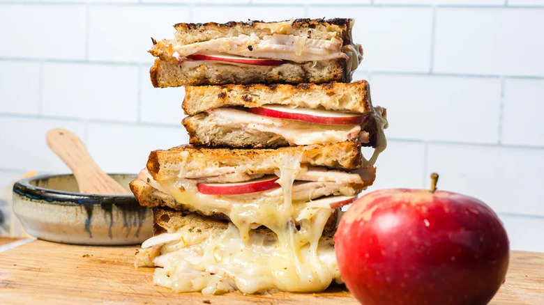 Apple Turkey Cheddar Sandwich stacked on wooden surface
