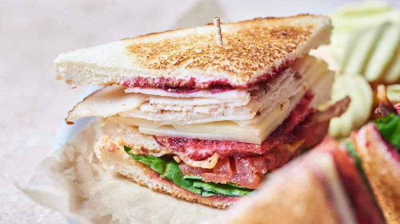 Sweet and Savory Club Sandwich with toothpick on plate