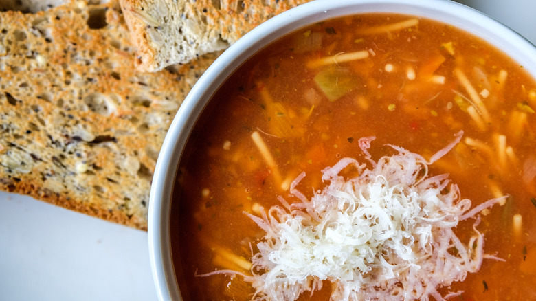 Bowl of minestrone soup with fresh grated cheese on top
