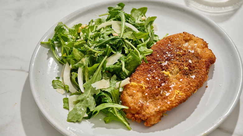 chicken milanese on a plate on a table