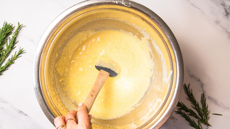 Folding cake batter in bowl.