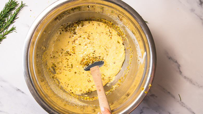 Folding cake batter in bowl.