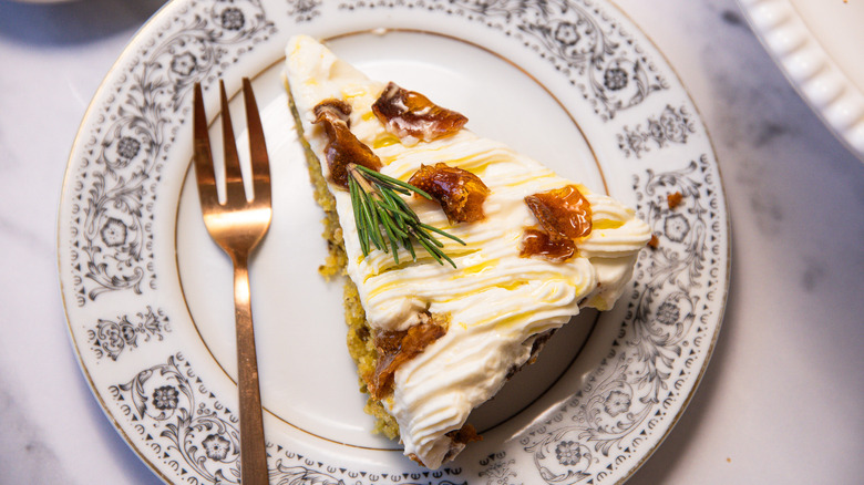 Slice of gluten-free lemon olive oil cake on a plate with fork.