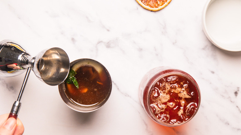Adding cocktail ingredients to shaker