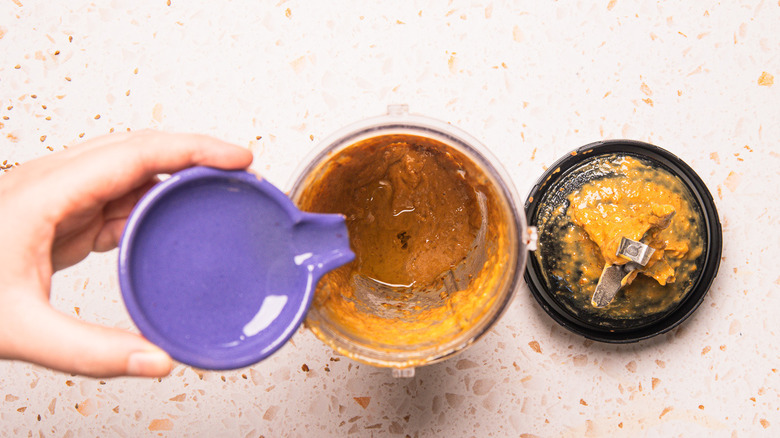 Emulsifying sauce with oil.