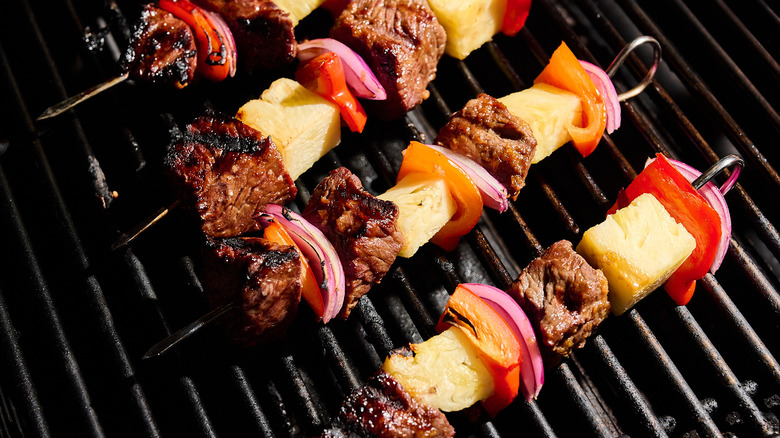 grilling beef kabobs on grill