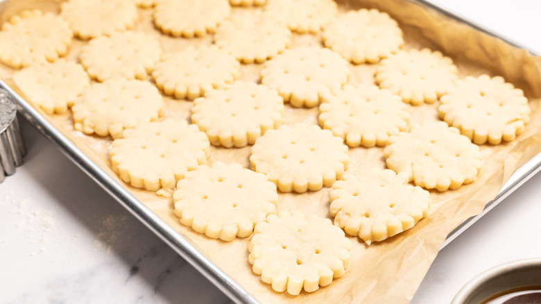 Overhead view of shortbread cookies on baking sheet.