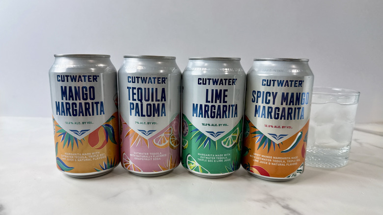 cans of Cutwater tequila cocktails and glass with cocktail