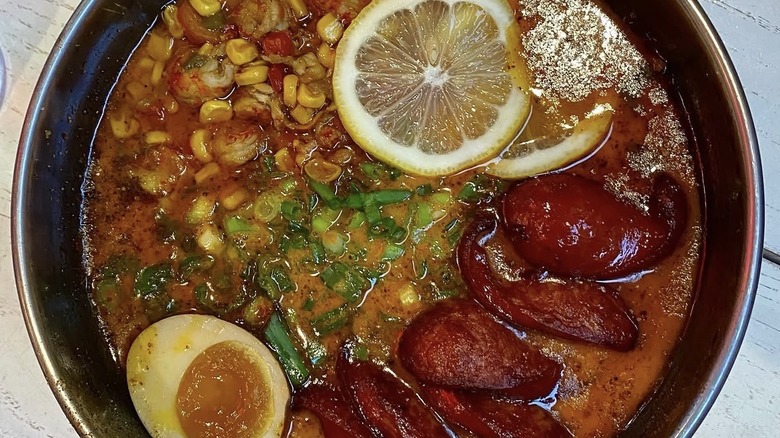 Ramen with crawfish, soft-boiled egg, corn, and lemon