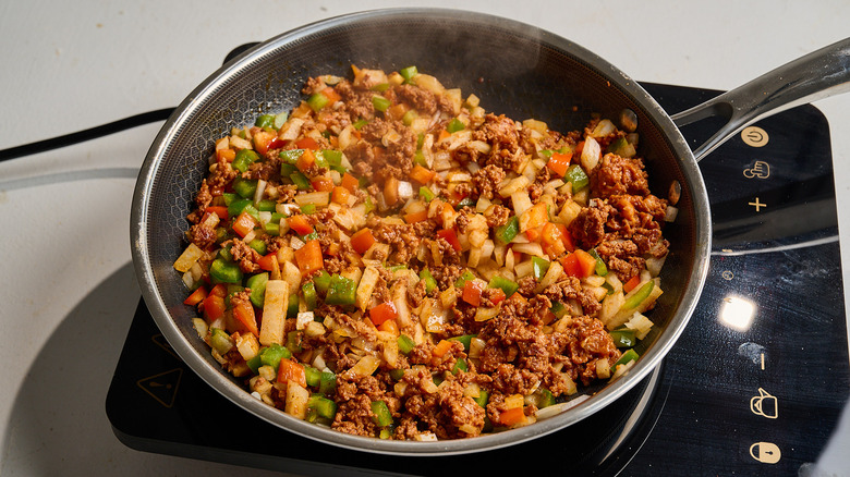 cooking chorizo with bell peppers and onions