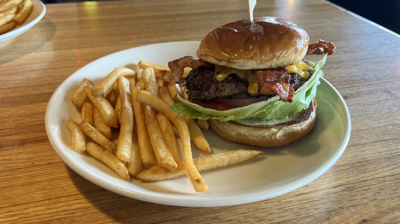 Applebee's Classic Bacon Cheeseburger and fries on plate.