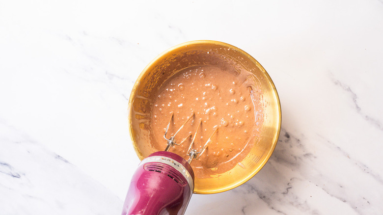 Chocolate liquid in bowl with mixer