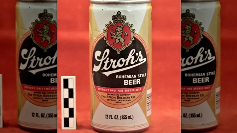 An old can of Stroh's beer on an orange background