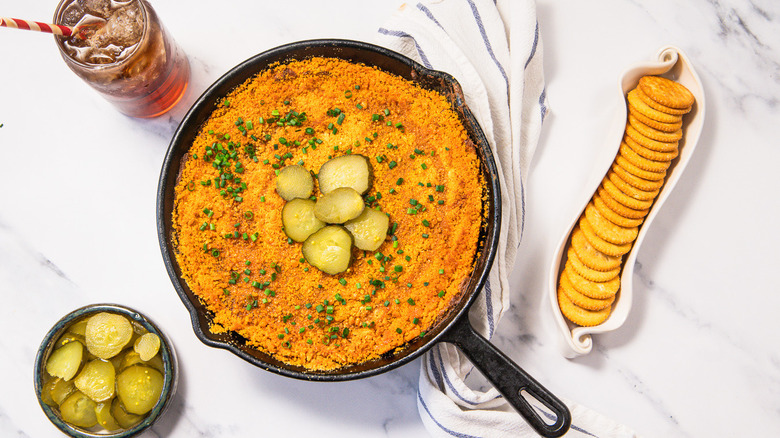 Nashville hot chicken dip with pickle slices and crackers