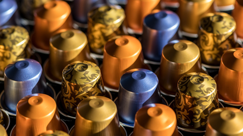 Rows of Nespresso coffee capsules in various colors