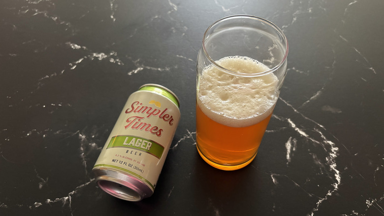 Trader Joe's Simpler Times lager can next to glass of beer