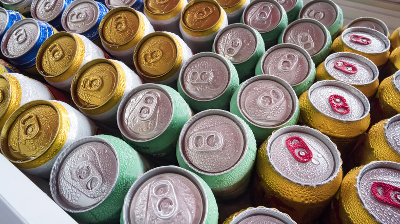 Stacked frosted beer cans in a fridge
