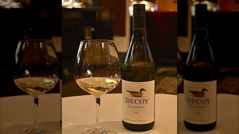 a bottle and glass of Decoy California Chardonnay white wine